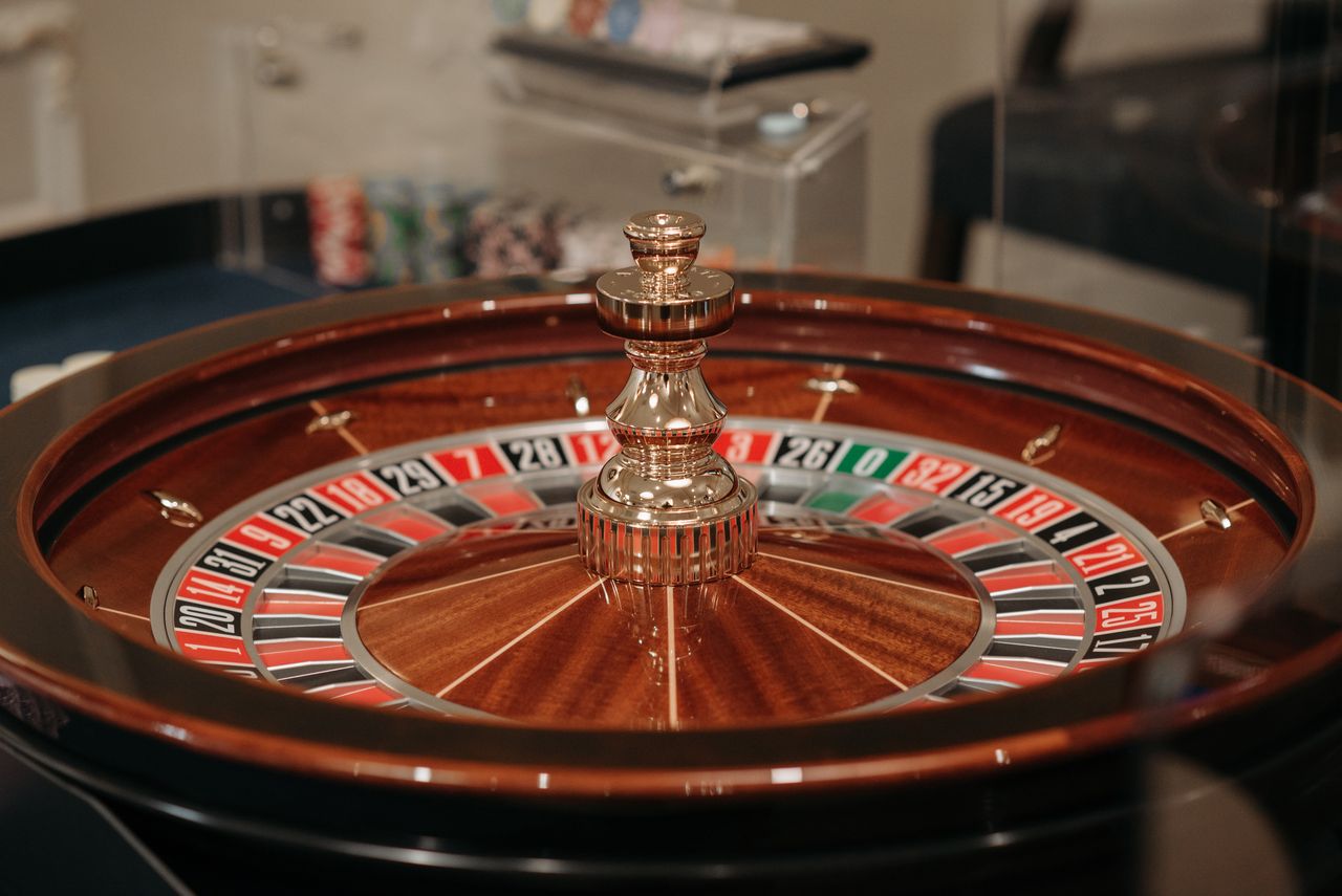 Polished wooden roulette wheel with brass spindle in the casino lounge