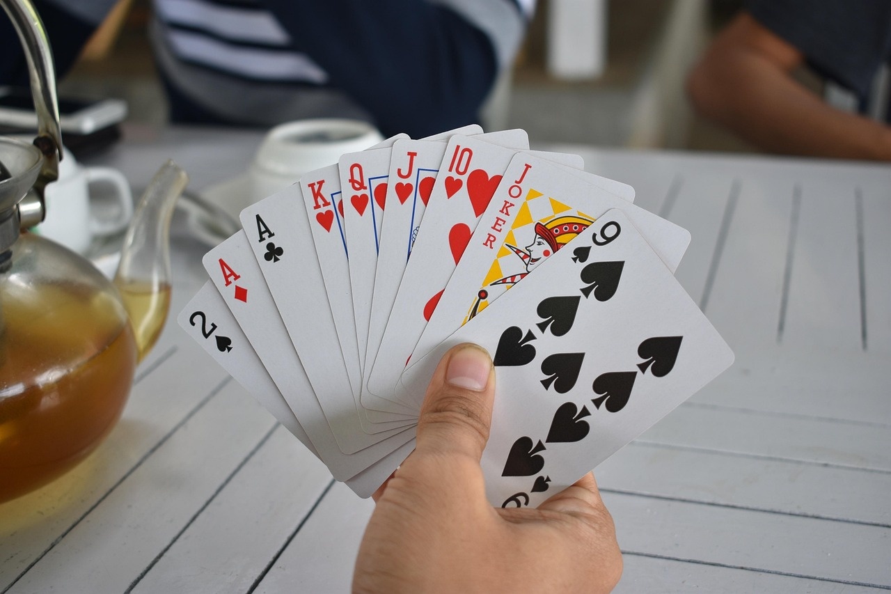 Guests sharing cards and tea, a British social evening beyond the gaming floor