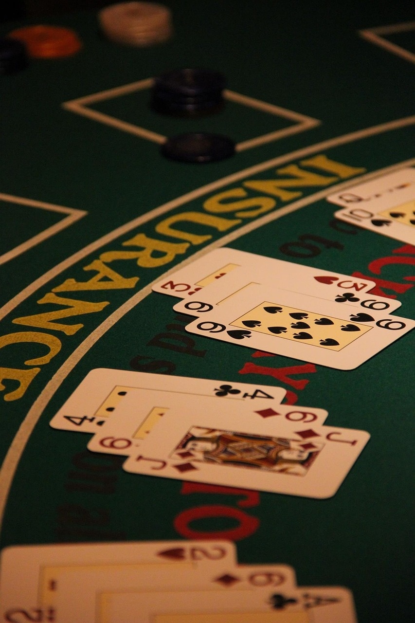 Blackjack layout with dealt cards and the insurance line in brass lettering