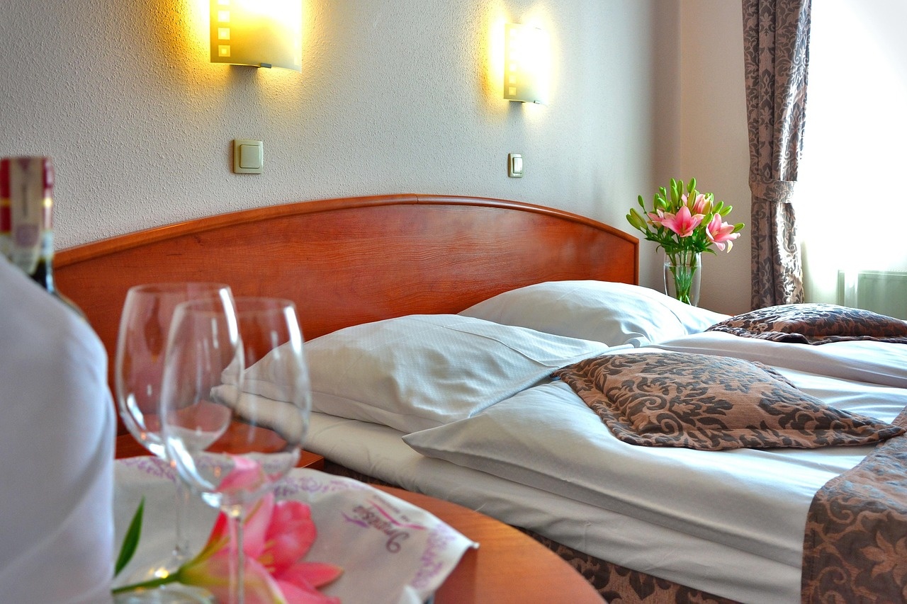 Wine glasses and lily service set before a warmly lit guest room
